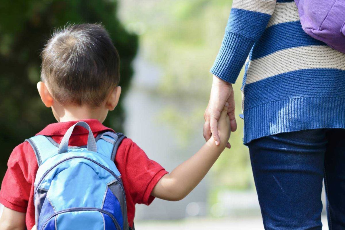 Child and mother walking hand in hand